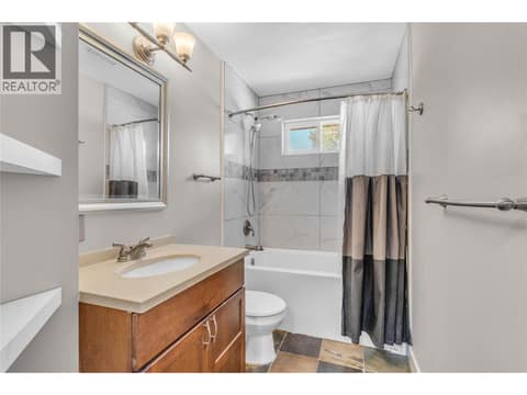 Full bathroom on the main level at 240 Petch Road, Rutland South, Kelowna