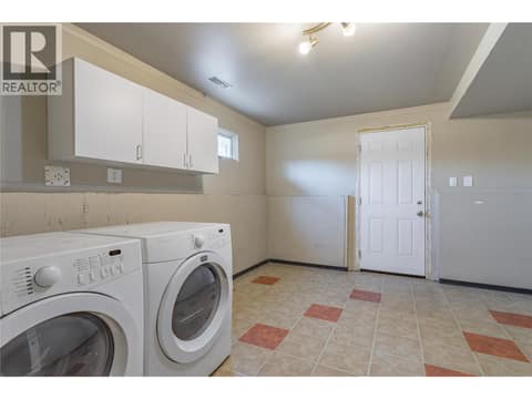 Laundry/utility room with walk out access at 240 Petch Road, Rutland South, Kelowna