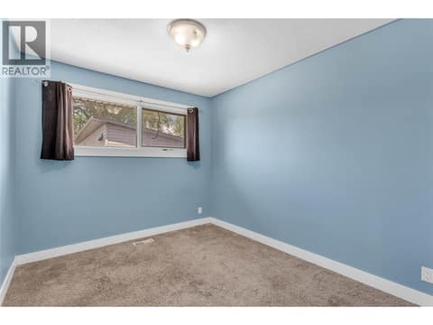 Second bedroom on the main level at 240 Petch Road, Rutland South, Kelowna