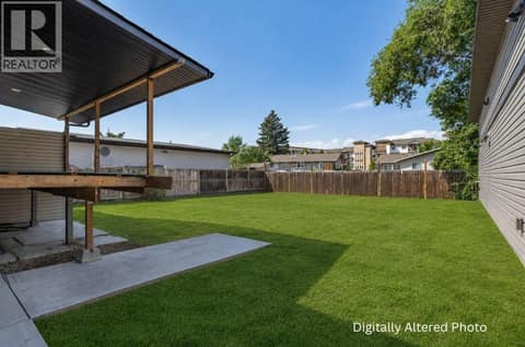 Spacious backyard. Digitally Altered Photo at 240 Petch Road, Rutland South, Kelowna