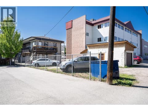 Blue garbage dumpster and parking area at 3601 31 Street, City of Vernon