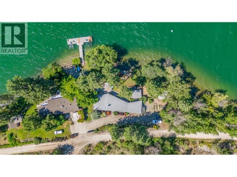 Area view. Home on the right and shared dock at 12110 Trewhitt Road W, Lake Country East / Oyama