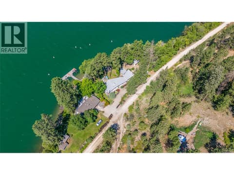 The lot encompasses the water frontage and a bonus portion larger than the first on the opposite side of the rail trail at 12110 Trewhitt Road W, Lake Country East / Oyama
