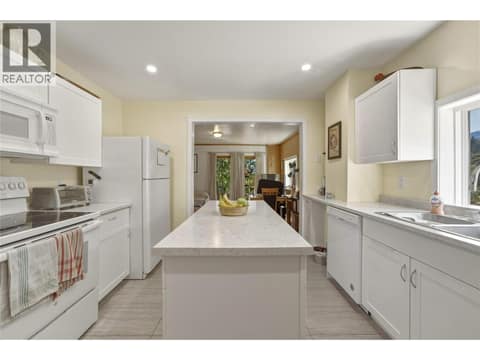 Dining area looking towards kitchen at 244 Mabel Lake Road, Lumby Valley
