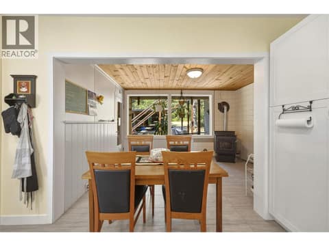 Kitchen looking towards dining area and pellet stove at 244 Mabel Lake Road, Lumby Valley