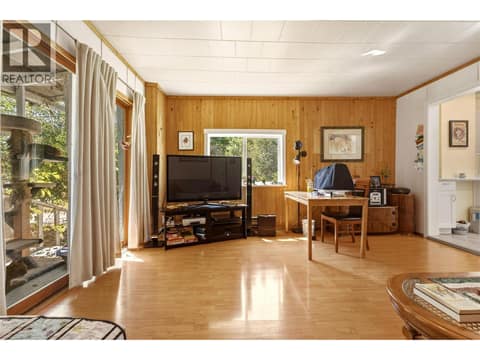 Living room with screened in porch on the left at 244 Mabel Lake Road, Lumby Valley