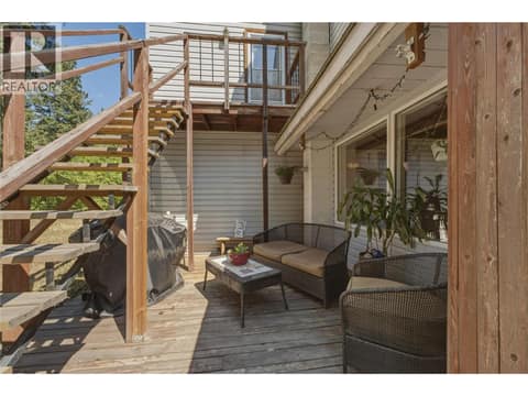 Sitting area with stairs to upper level at 244 Mabel Lake Road, Lumby Valley