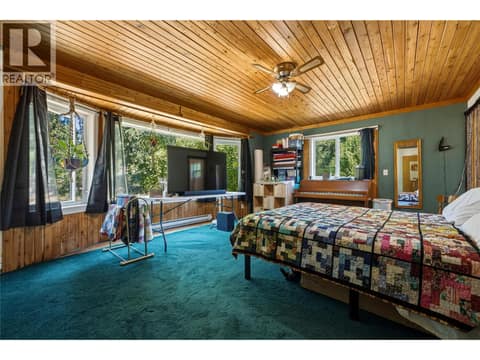Spacious primary bedroom on main level at 244 Mabel Lake Road, Lumby Valley