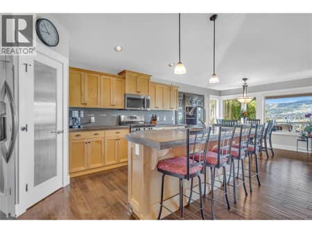 Concrete counters in the sit up bar kitchen at 2493 Ironridge Road, Smith Creek, West Kelowna