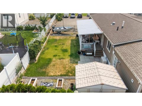 Aerial view highlights the generous yard, covered deck, garden areas and additional outdoor storage. at 9020 Jim Bailey Road Unit# 151, Lake Country East / Oyama, Kelowna