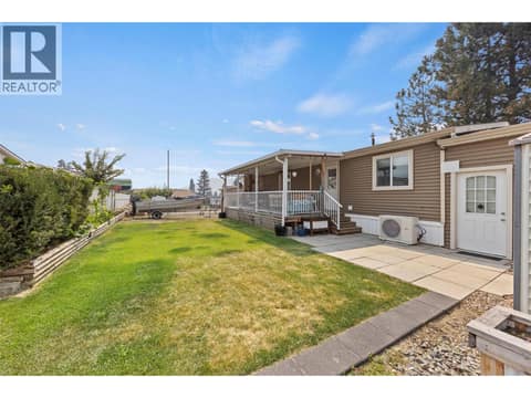 Another view showcasing the size of the yard, covered deck and the amount of usable outdoor space this home offers. at 9020 Jim Bailey Road Unit# 151, Lake Country East / Oyama, Kelowna