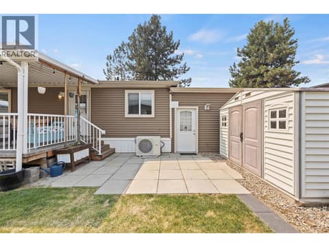 Convenient private exterior entrance to the garage/workshop area, along with a paved patio area and large storage shed. at 9020 Jim Bailey Road Unit# 151, Lake Country East / Oyama, Kelowna