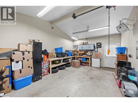 The garage provides impressive additional space with high ceilings, abundant lighting, built-in work surfaces and convenient direct access to the yard. at 9020 Jim Bailey Road Unit# 151, Lake Country East / Oyama, Kelowna
