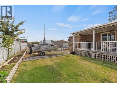 The spacious yard connects beautifully with the covered deck, creating an easy indoor-outdoor lifestyle with room to entertain and enjoy the outdoors. at 9020 Jim Bailey Road Unit# 151, Lake Country East / Oyama, Kelowna