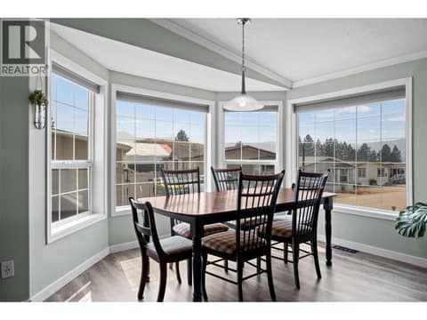 This bright dining area is a standout, surrounded by expansive windows that fill the space with natural light and create a wonderful spot to enjoy your morning coffee or gather for dinner. at 9020 Jim Bailey Road Unit# 151, Lake Country East / Oyama, Kelowna
