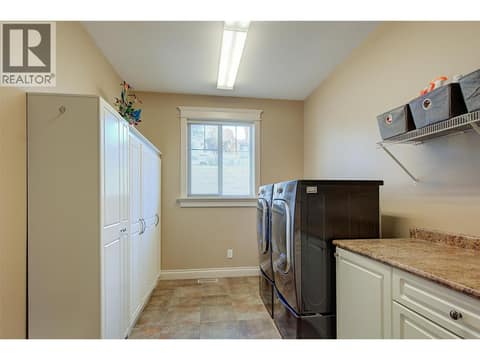 Laundry Room/Mud Room access from Double Garage at 1095 Hume Avenue, Black Mountain, Kelowna