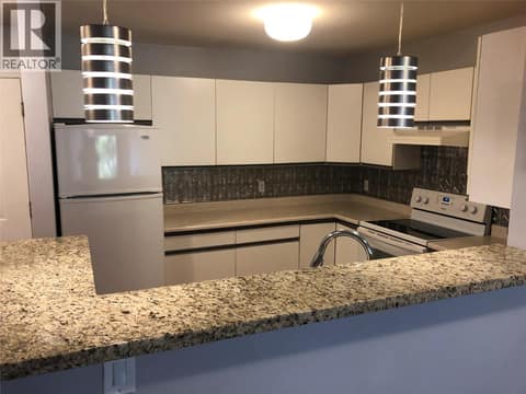 Kitchen with Open View to dining and living room. at 400 Sutton Crescent Unit# 310 Lot# 42, North Glenmore, Kelowna