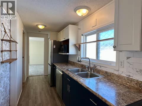 Hallway to primary bedroom at 12560 Westside Road Unit# 26, Swan Lake West, Vernon