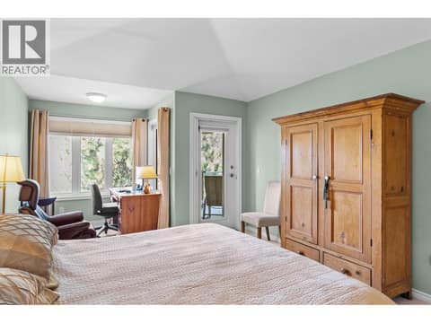 Primary bedroom with access to view deck. at 4400 Gallaghers Drive E Unit# 2, South East Kelowna