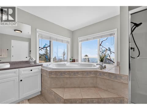 Primary ensuite with soaker tub & a walk-in shower at 3491 Fenton Road, Glenrosa, West Kelowna