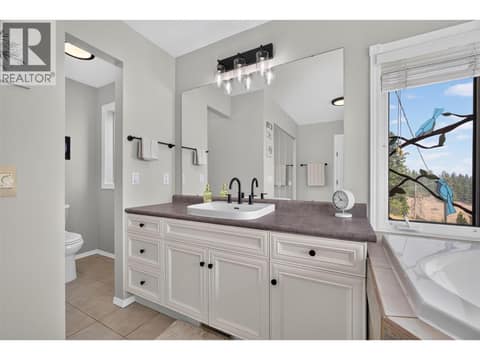Primary ensuite with soaker tub & a walk-in shower at 3491 Fenton Road, Glenrosa, West Kelowna