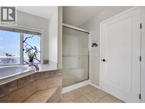 Primary ensuite with soaker tub & a walk-in shower at 3491 Fenton Road, Glenrosa, West Kelowna