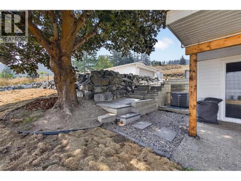 Steps down to the lower level entrance at 3491 Fenton Road, Glenrosa, West Kelowna