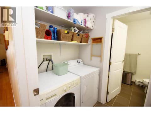 Laundry room leading to main 4pc bathroom at 4800 Heritage Drive Unit# 7, Westmount, Vernon