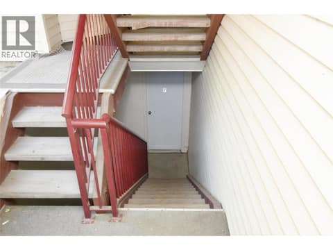 Stairs leading to storage area & garage on  lower level at 4800 Heritage Drive Unit# 7, Westmount, Vernon