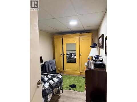 Lower level Bedroom - window behind armoir at 220 Prior Road S Unit# 1, Rutland South, Kelowna