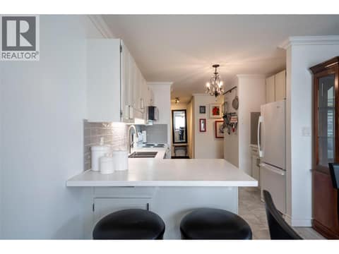 Kitchen - newer quartz countertops - open to dining room at 3608 27 Avenue Unit# 209, City of Vernon