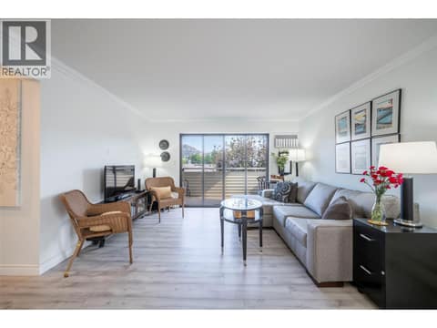 Living room with access to covered balcony at 3608 27 Avenue Unit# 209, City of Vernon