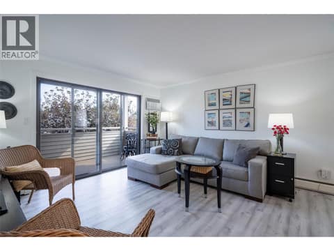 Living room with access to covered balcony at 3608 27 Avenue Unit# 209, City of Vernon