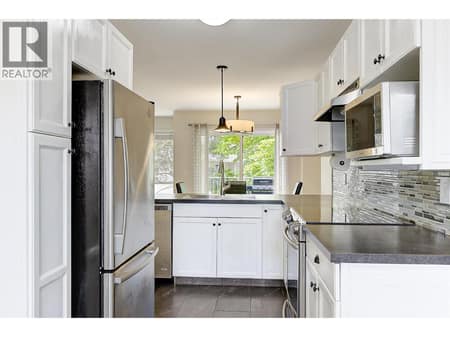Functional kitchen with stainless steel appliances at 133 Wyndham Crescent Unit# 110, North Glenmore, Kelowna