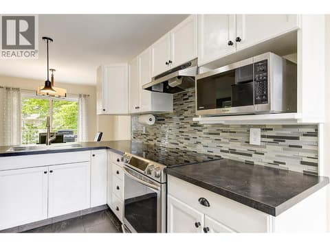 Functional kitchen with stainless steel appliances at 133 Wyndham Crescent Unit# 110, North Glenmore, Kelowna