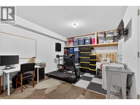 Flexible rear garage space with the potential to be enclosed into a separate room, making it ideal for a home office, gym, hobby room, or additional storage. at 720 Valley Road Unit# 28, North Glenmore, Kelowna