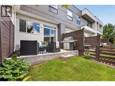 Private patio and grass area, perfect for summer BBQs, entertaining guests, or giving kids and pets space to enjoy outdoors. at 720 Valley Road Unit# 28, North Glenmore, Kelowna