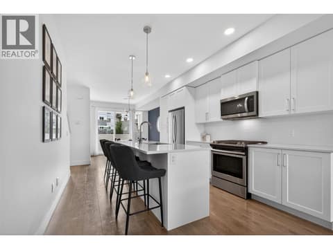 Spacious kitchen featuring a massive island, tons of counter space and storage, making it the perfect hub for entertaining and everyday living. at 720 Valley Road Unit# 28, North Glenmore, Kelowna