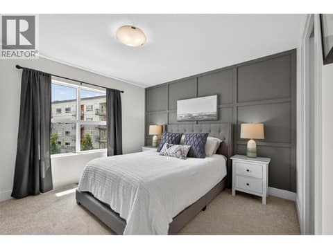 Spacious primary bedroom featuring great natural light, a walk-in closet, and a beautifully appointed ensuite with dual vanities and a tile shower. at 720 Valley Road Unit# 28, North Glenmore, Kelowna