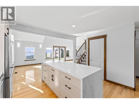 Kitchen | Main Level - Freshly renovated kitchen with quartz countertops, a waterfall island, and all new stainless steel appliances at 17936 Angus Road, Lake Country North West