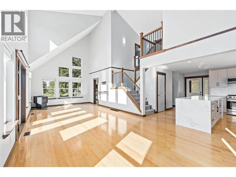 Living Room | Main Level - With tall vaulted ceilings, floor-to-ceiling windows & fireplace at 17936 Angus Road, Lake Country North West