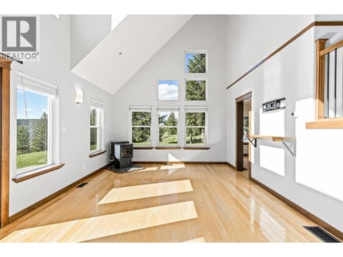 Living Room | Main Level - With tall vaulted ceilings, floor-to-ceiling windows & fireplace at 17936 Angus Road, Lake Country North West