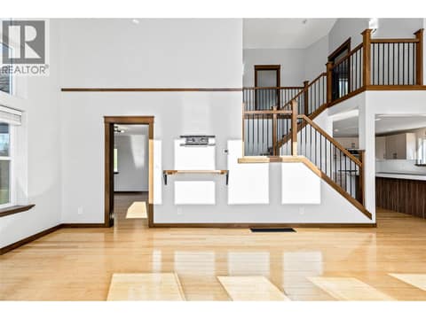 Living Room | Main Level - With tall vaulted ceilings, floor-to-ceiling windows & fireplace at 17936 Angus Road, Lake Country North West