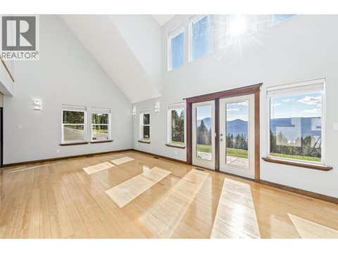 Living Room | Main Level - With tall vaulted ceilings, floor-to-ceiling windows & fireplace at 17936 Angus Road, Lake Country North West