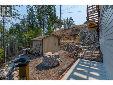 Lower level has a storage shed and a fire pit at 10818 Westshore Road, Okanagan North, Vernon