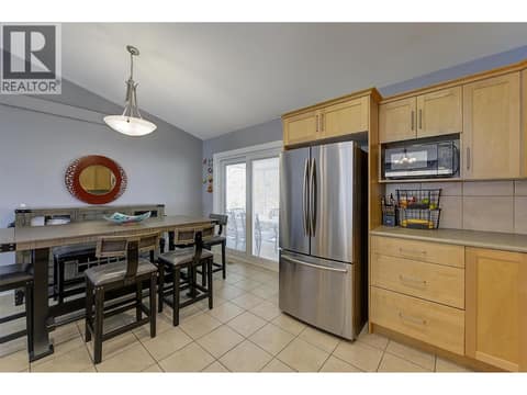 Dining room slider opens to rear patio with spacious dining and a near brand new hot tub at 2352 SELKIRK Drive Lot# 37, Dilworth Mountain, Kelowna
