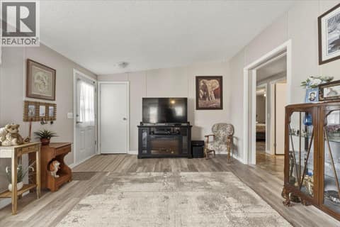Front door on left with coat closet at 12560 Westside Road Unit# 77, Swan Lake West, Vernon