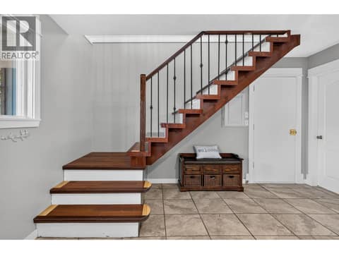 Hardwood stair case to main floor at 2848 Inverness Road, Glenrosa, West Kelowna