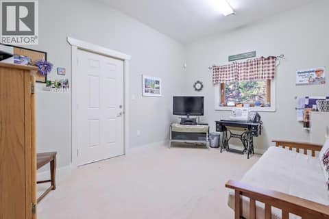 Lower Bedroom/Den with exit to lower patio at 6709 VICTORIA Road S Unit# 6, Summerland Rural