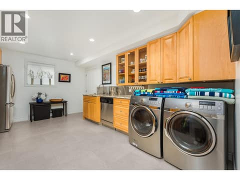 Lower level kitchen with laundry at 8615 Okanagan Landing Road, Okanagan Landing, Vernon